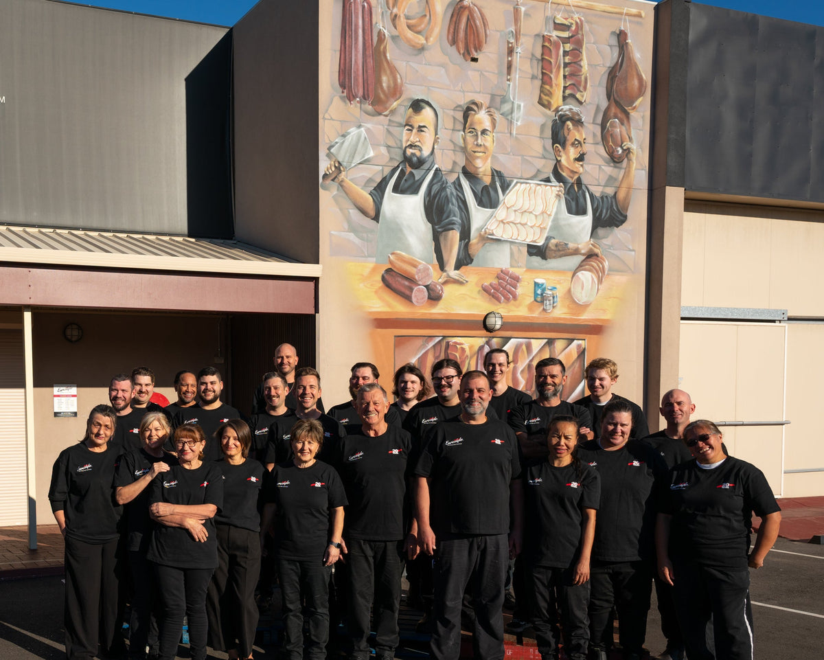 The Eurostyle Smallgoods team in front of the shop mural at Bibra Lake
